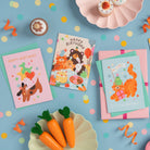 Birthday cards with colorful illustrations on a blue background with confetti and carrots.