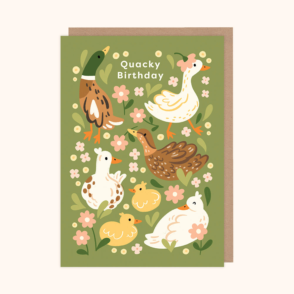 A greeting card with a green background featuring illustrations of various ducks and flowers, with the text 'Quacky Birthday' at the top.