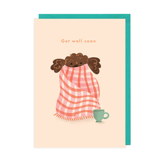 A get well soon card featuring an illustration of a fluffy brown dog wrapped up in a blanket. 