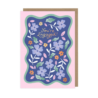 A floral engagement card which reads "you're engaged!". 