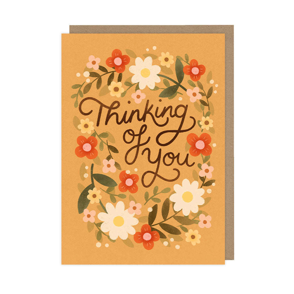 Floral-themed 'Thinking of You' greeting card featuring a hand-drawn wreath of colourful flowers in warm tones. Includes matching kraft envelope, perfect for sympathy, encouragement, or just because