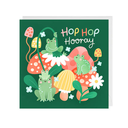 A birthday card featuring cute frogs playing on colourful mushrooms, and reads "Hop Hop Hooray!"