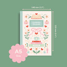 Reading journal with decorative cover and dimensions on a green background