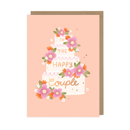 A wedding card featuring a cake adorned with flowers that reads "to the happy couple".