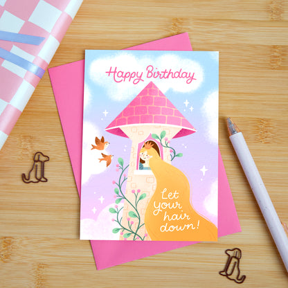 A princess themed birthday card featuring a woman in a tower with long flowing hair. The card reads "happy birthday, let you hair down". 