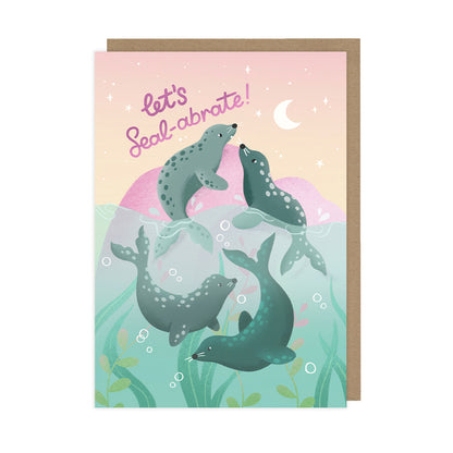 A birthday card featuring four playful seals and reads "let's seal-abrate".