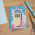 A photograph of a new home card featuring a cockapoo dog. 