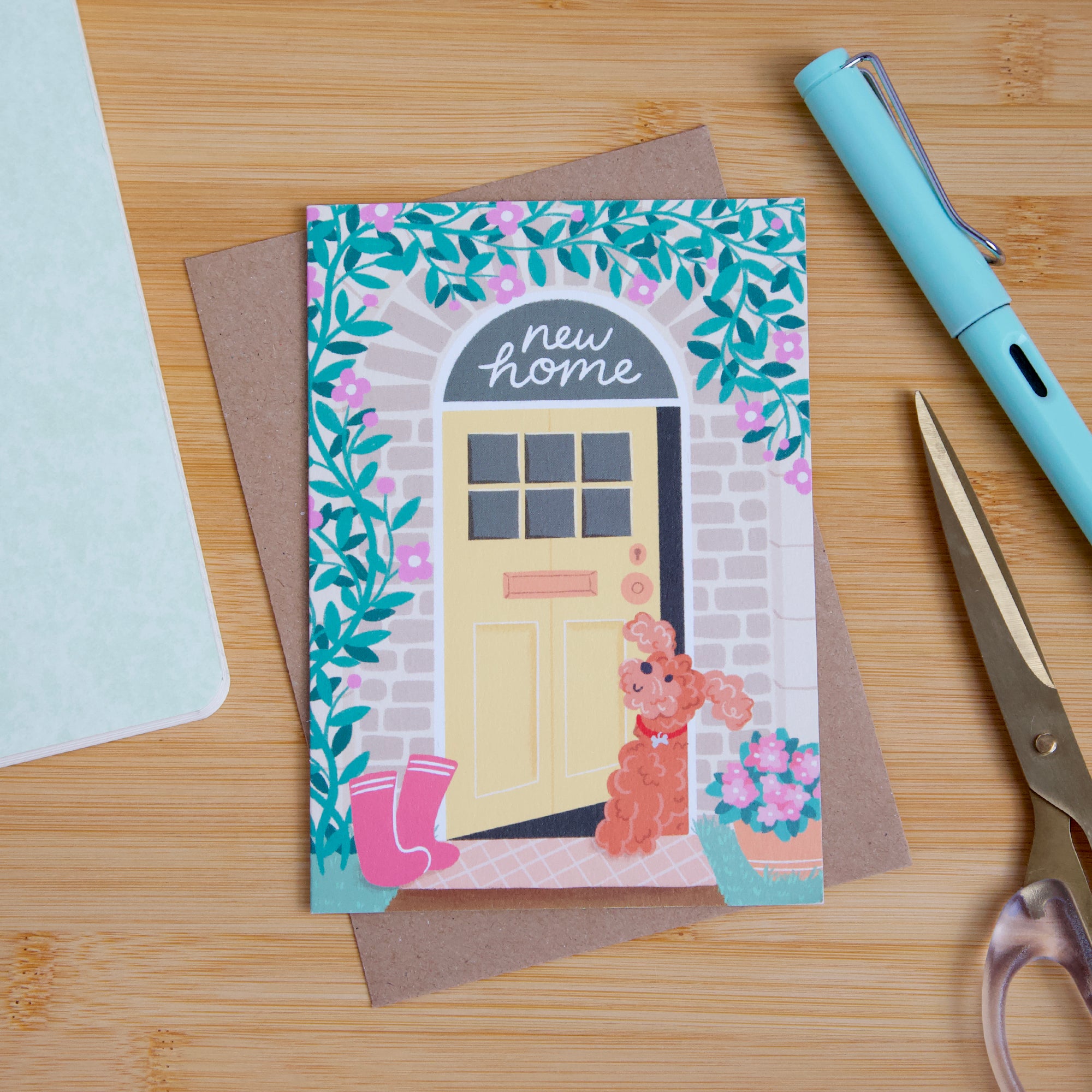 A photograph of a new home card featuring a cockapoo dog. 