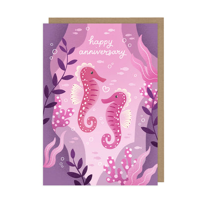 A pink anniversary card featuring two seahorses and reads "happy anniversary". 