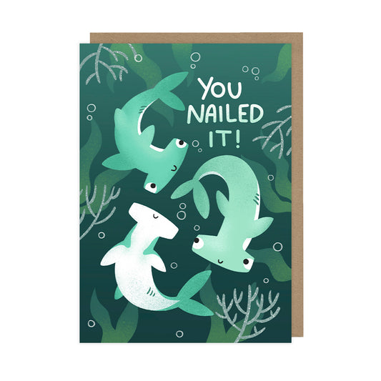 A congratulations card featuring cute smiling hammerhead sharks that reads "you nailed it!". 