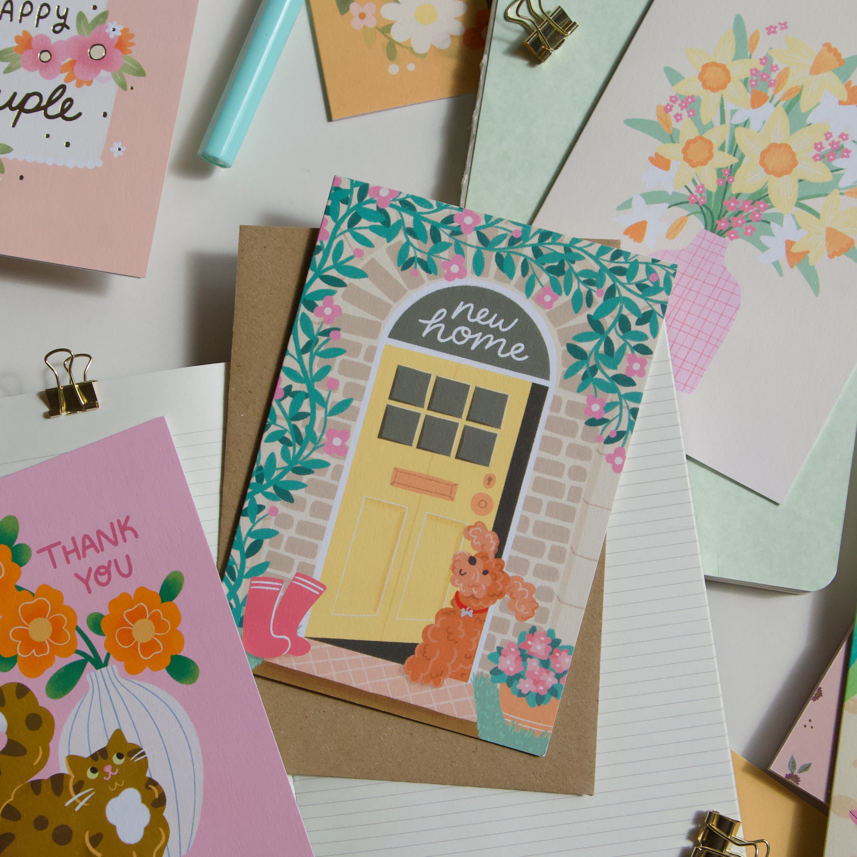 A photograph of a collection of cards featuring a cockapoo dog new home card. 
