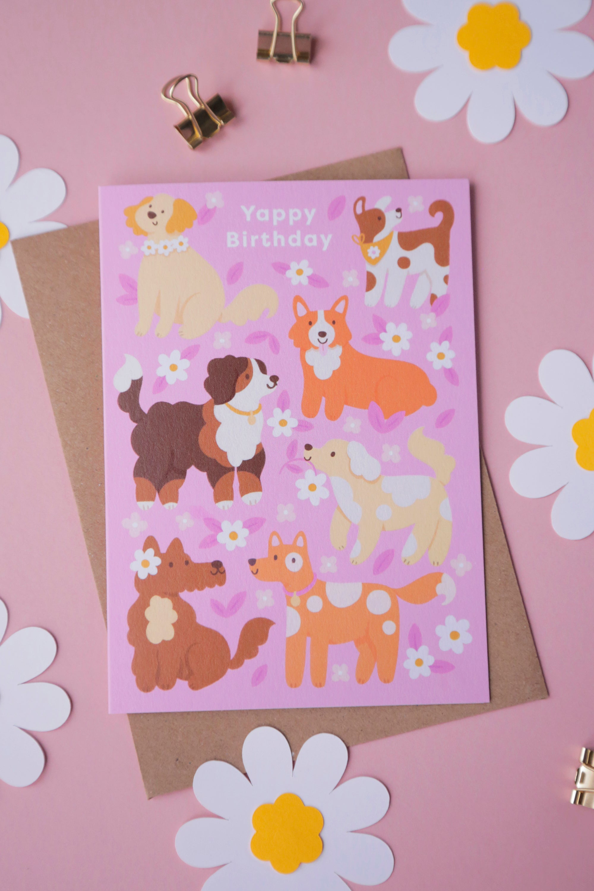 A photograph of a birthday card featuring illustrated dogs.